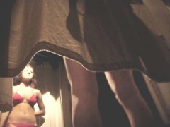 Cute brunette is caught in a dressing room changing on hidd