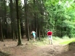 A teenage girl is jogging through the forest with her