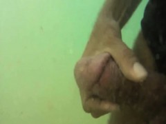 Underwater spy cam films a dude jerking off until he shoots