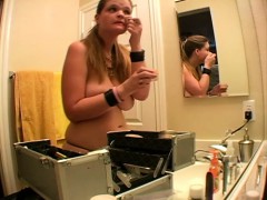 This cute busty blonde loves to go topless while she puts her makeup on