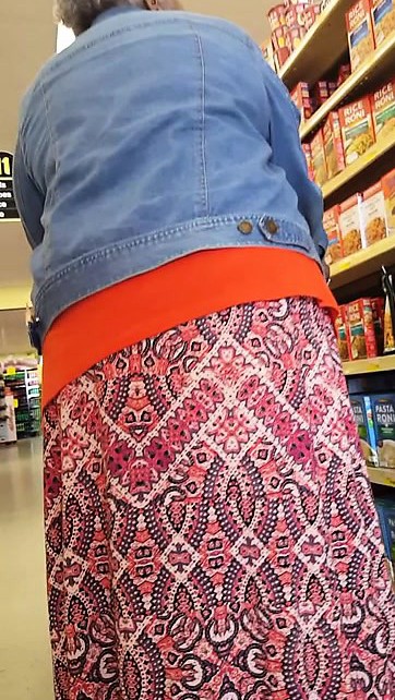 Good-looking older woman reveals her hot panties while shop