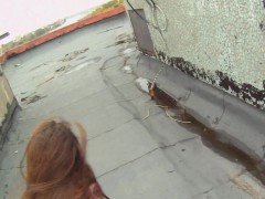 Dazzling redhead sucks a big pole and takes a hard fucking on the roof