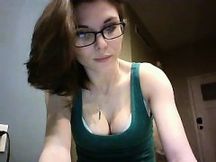 Geeky brunette displays her delicious cleavage in a green t