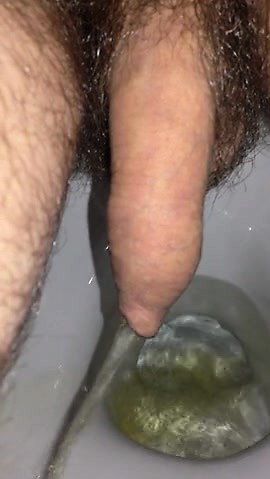 Close up pissing through foreskin