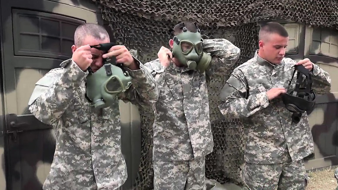 Military hunks in gas masks fuck and suck