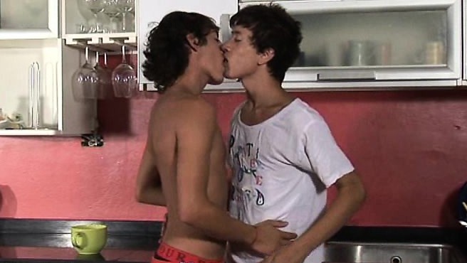 Passionate twinks kiss and go down in the kitchen