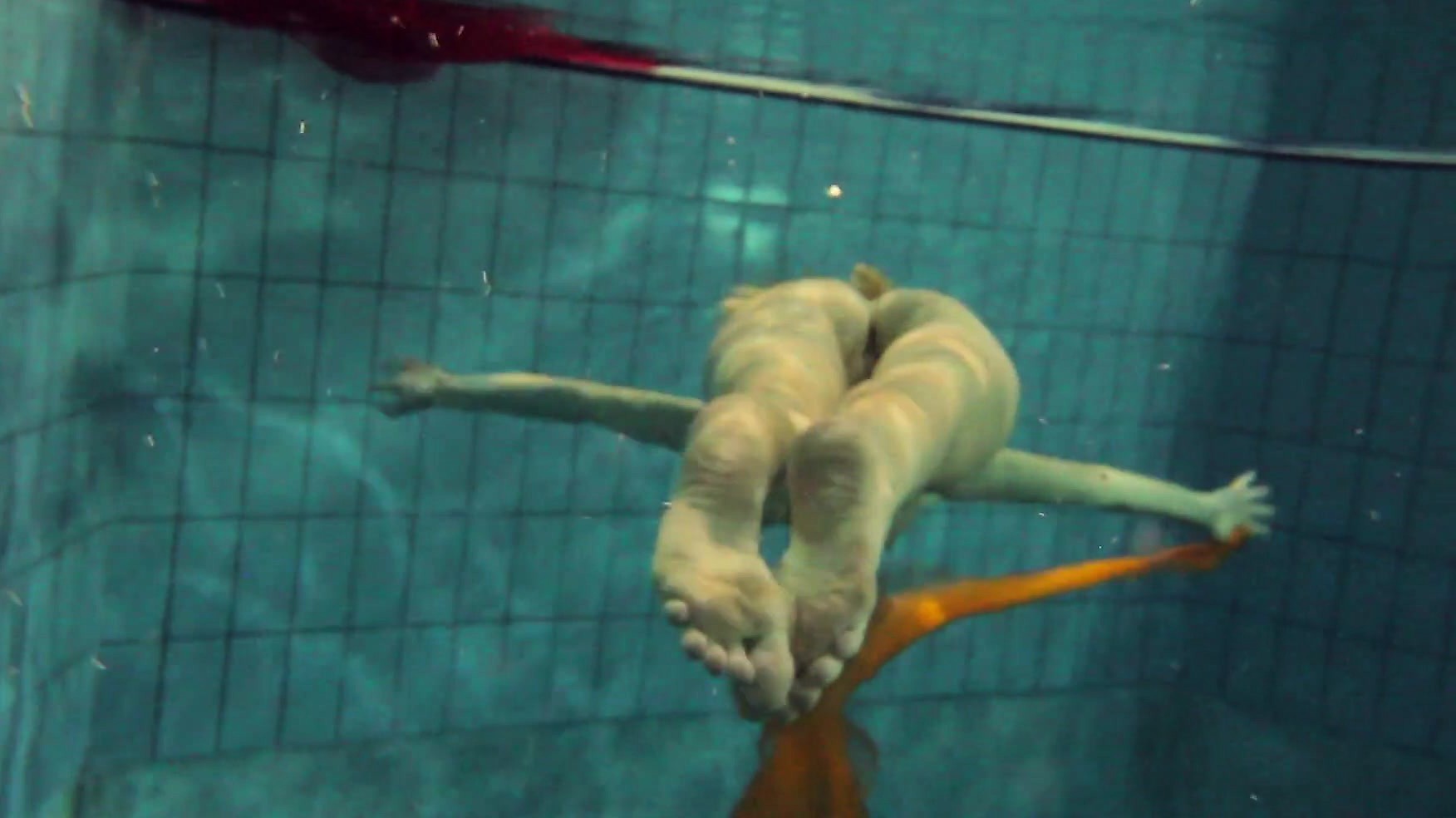 Yellow and Red clothed teen underwater