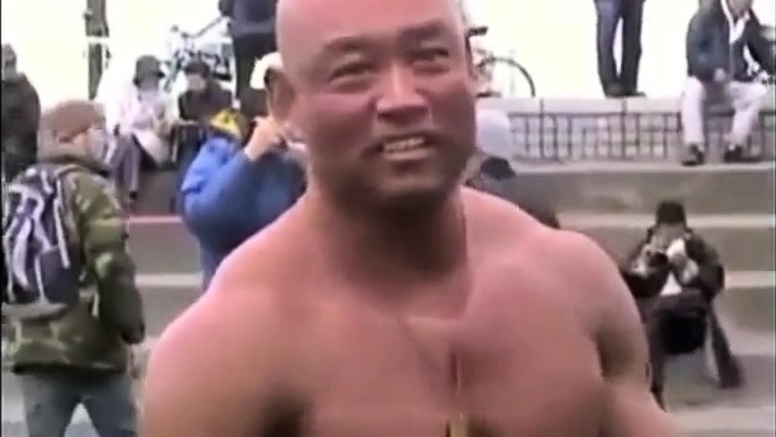 Asian bodybuilder barely covered at the beach