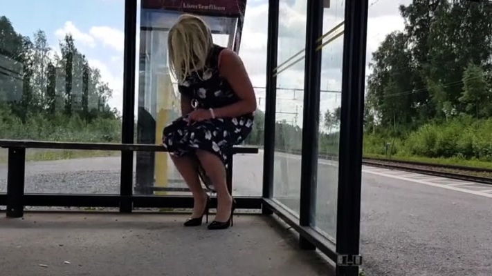 HannaTransa Chastity Crossdresser outdoors at train station.