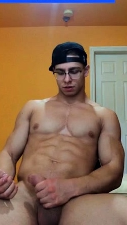 Muscular Guy in glasses jerking off and cumming