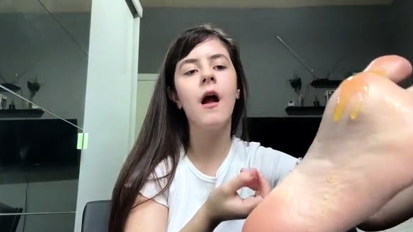 Cute teen girl enjoys foot fetish