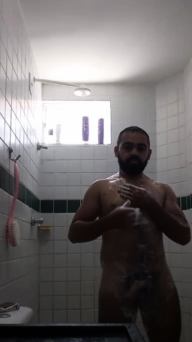 A guy with big pubic hair taking a shower