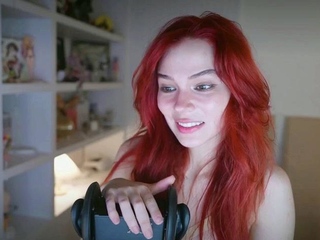 Redheaded pierced teen close up toy show